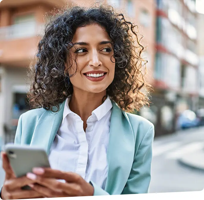 Business woman on a street corner with smart phone