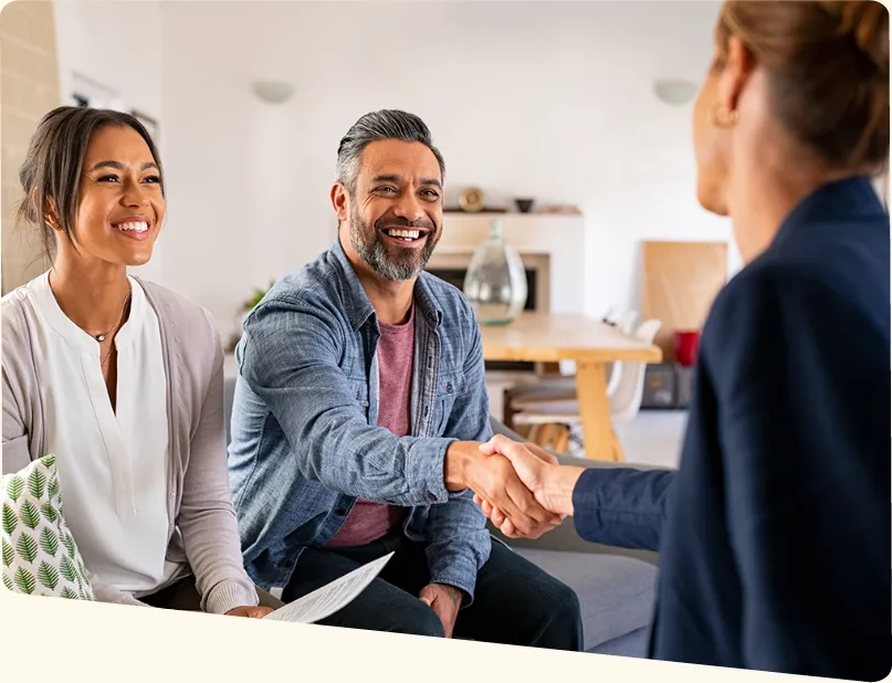 Couple shaking hands with real estate agent